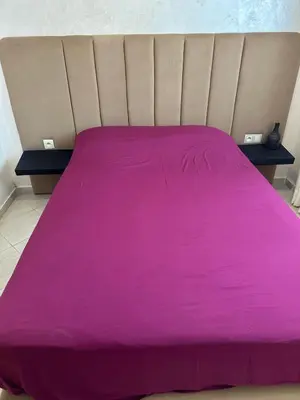 a bed with a pink blanket on top of it at Appartement 2 chambre cosy in Marrakech