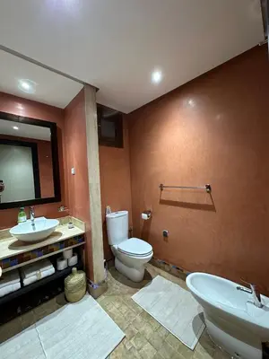 a bathroom with a toilet and a sink and a mirror at Oasis de Charme au coeur de la zone touristique in Marrakech