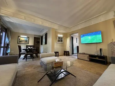 a large living room with a large tv on the wall at Oasis de Charme au coeur de la zone touristique in Marrakech