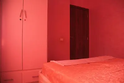 a red bedroom with a bed and a wardrobe at apartment,5 min to airport, In a quiet place in Marrakech