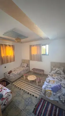 a living room with two beds and a couch at Aéroport hostel et chambre appartement studio Marrakech in Marrakech