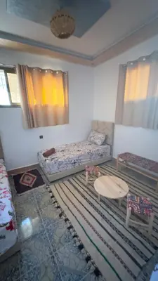 a living room with a couch and a table at Aéroport hostel et chambre appartement studio Marrakech in Marrakech