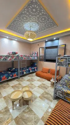 a dorm room with bunk beds and a couch at Aéroport hostel et chambre appartement studio Marrakech in Marrakech