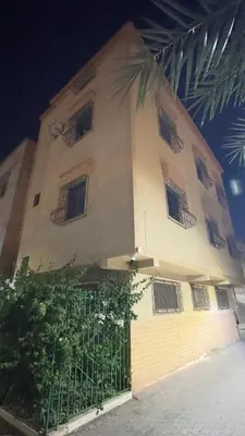 a building with barred windows and a fence at Aéroport hostel et chambre appartement studio Marrakech in Marrakech