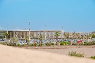 a parking lot with a lot of cars at Aéroport hostel et chambre appartement studio Marrakech in Marrakech