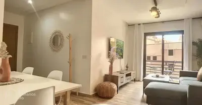 a living room with a couch and a table at Apartments giliz Marrakech in Marrakech