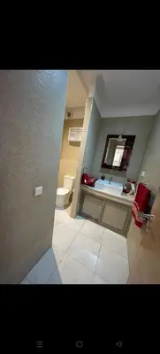 a bathroom with a sink and a toilet and a mirror at Location haut standing au cœur de Marrakech in Marrakech