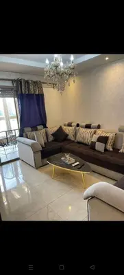 a living room with a couch and a table at Location haut standing au cœur de Marrakech in Marrakech