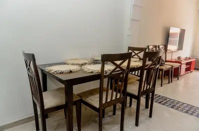 a dining room with a table and four chairs at Appartement 2 bedroom Babylone center in Marrakech