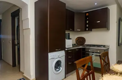 a kitchen with a washing machine and a washer at Appartement 2 bedroom Babylone center in Marrakech