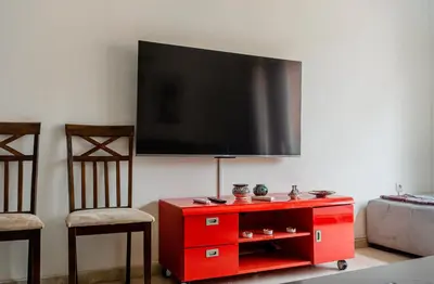 a red entertainment center with a flat screen tv on a wall at Appartement 2 bedroom Babylone center in Marrakech