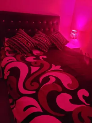 a bedroom with a bed with a black and red blanket at Au cœur de l orient Marrakech in Marrakech
