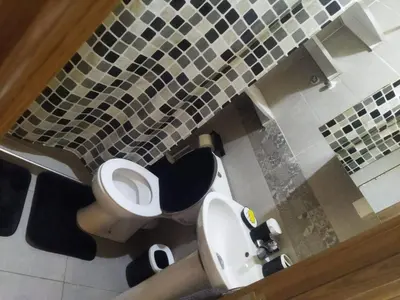 a bathroom with a white toilet and a sink at Au cœur de l orient Marrakech in Marrakech