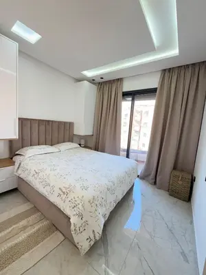 a bedroom with a bed and a large window at Marrakech charme urbain à l'hivernage in Marrakech