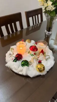 a plate with christmas decorations on a table with candles at Marrakech charme urbain à l'hivernage in Marrakech