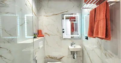 a white bathroom with a sink and a mirror at Marrakech charme urbain à l'hivernage in Marrakech