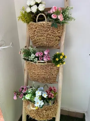 a ladder with flowers in baskets on it at Guéliz Bright apartment with pools in Marrakech