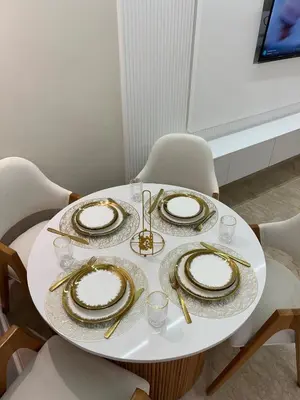 a table with plates and gold chargers on it at Guéliz Bright apartment with pools in Marrakech