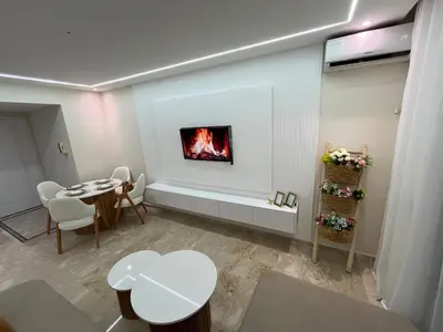 a living room with a table and a fireplace at Guéliz Bright apartment with pools in Marrakech