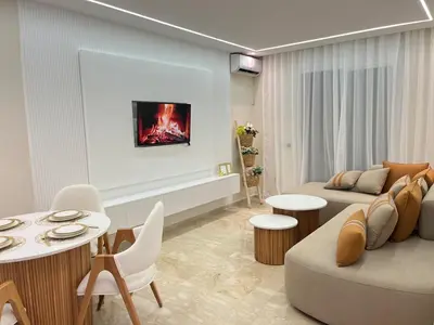 a living room with a couch and a table at Guéliz Bright apartment with pools in Marrakech