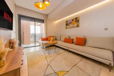 a living room with a couch and a table at Appartement Plaza Madani in Marrakech