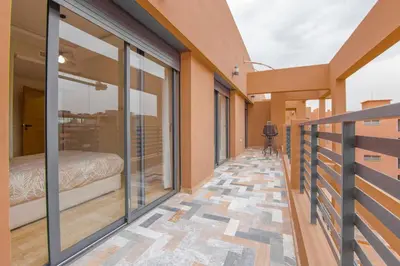 a balcony of a house with a bed on it at Appartement Plaza Madani in Marrakech