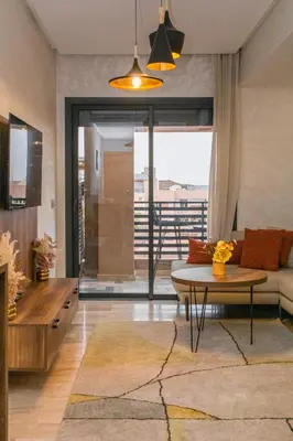 a living room with a couch and a table at Appartement Plaza Madani in Marrakech