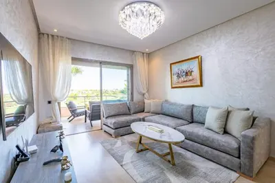 a living room with a couch and a table at Spacious Apartment, Golf & Pool in Marrakech