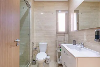 a bathroom with a toilet and a sink and a shower at Spacious Apartment, Golf & Pool in Marrakech