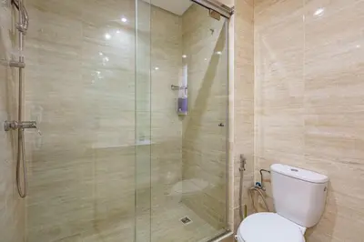 a bathroom with a toilet and a glass shower at Spacious Apartment, Golf & Pool in Marrakech