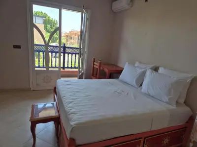 a bedroom with a large bed with a window at Villa Kaina in Marrakech