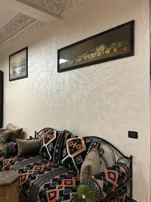 a bedroom with a bed and a painting on the wall at Dar Daroune in Marrakech