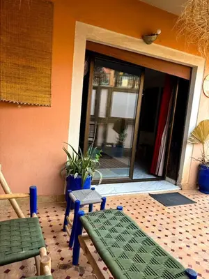 a patio with a bench and a sliding glass door at Happy House 2 in Marrakech