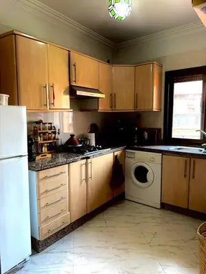 a kitchen with a white refrigerator and a dishwasher at Happy House 2 in Marrakech
