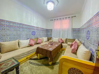 a living room with a couch and a table at Dar AINA in Marrakech