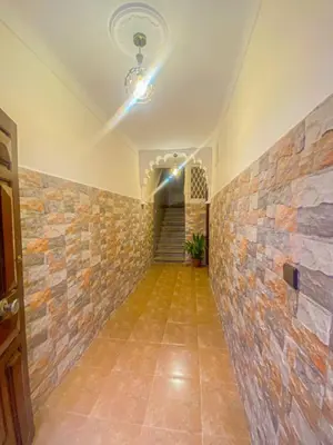a hallway with a stone wall and a ceiling at Dar AINA in Marrakech