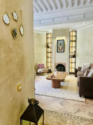 a living room with a couch and a table at Le Palmito - 2BDR - Private Garden - Pool in Marrakech
