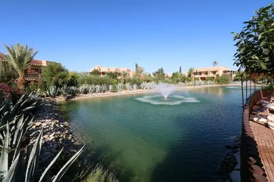 a pond with a fountain in the middle of the water at Le Palmito - 2BDR - Private Garden - Pool in Marrakech