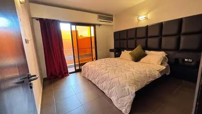 a bedroom with a large bed with a large headboard at Apartment Ghita Cozy Stay in Central Marrakech in Marrakech