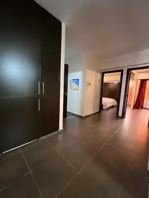a room with a large black cabinet and a bedroom at Apartment Ghita Cozy Stay in Central Marrakech in Marrakech
