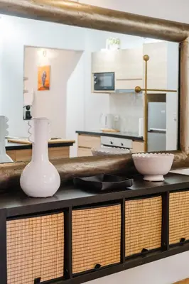 a kitchen with a table with a white vase on it at Elegant and Confort Moderne au Coeur de la Ville in Marrakech