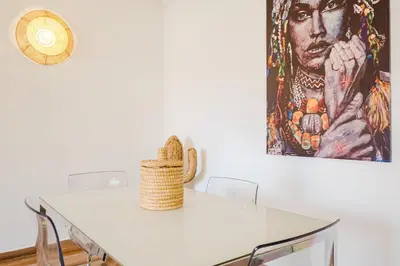 a white dining room table with a painting on the wall at Elegant and Confort Moderne au Coeur de la Ville in Marrakech