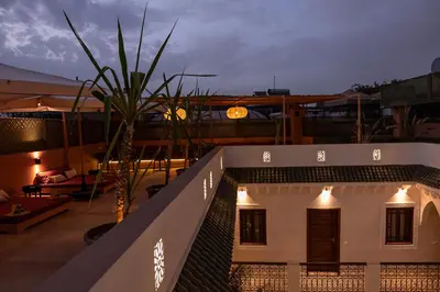 a house with lights on the roof at night at Riad Dar Melia in Marrakech