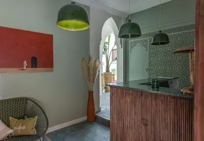 a kitchen with green pendant lights and a counter at Riad Dar Melia in Marrakech
