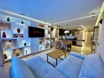 a living room with a blue couch and a table at Modern Oasis in Gueliz - Balcony & Comfort in Marrakech