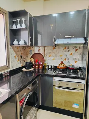 a kitchen with a stove and a sink at Appart chaleureux et calme, fibre et Netflix in Marrakech