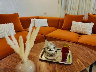 a living room with a couch and a coffee table at Appart chaleureux et calme, fibre et Netflix in Marrakech