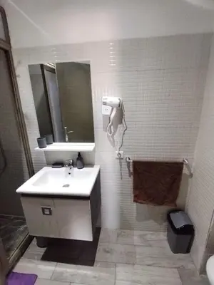 a bathroom with a sink and a mirror and a toilet at Appartement luxueux à louer in Marrakech