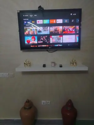 a flat screen tv hanging on a wall at Appartement luxueux à louer in Marrakech