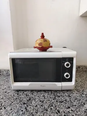 a white microwave sitting on top of a counter at Appartement luxueux à louer in Marrakech
